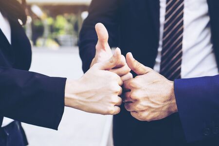 close up hand of business  people bump hands thumb up finishing up meeting showing unity , business teamwork conceptの写真素材