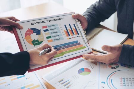 close up hand of marketing manager employee pointing at business document during discussion at...