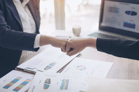 close up hand of business  people bump hands finishing up meeting showing unity , business teamwork conceptの写真素材