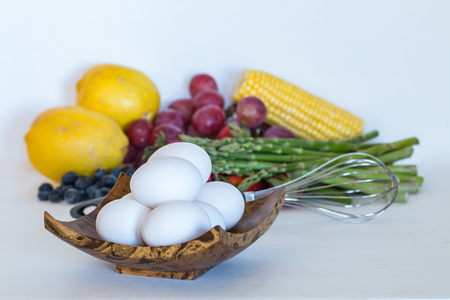 Eggs, fruits and vegetables on white background.の写真素材