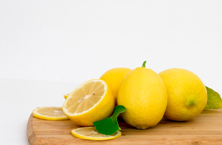 Fresh lemons on wooden block.の写真素材