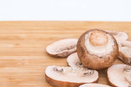 Fresh organic baby bella mushrooms on  wooden block.の写真素材