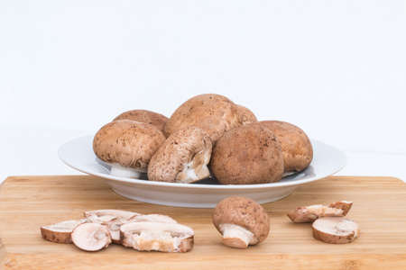 Fresh organic baby bella mushrooms on  wooden block.の写真素材