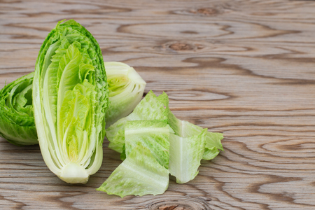Fresh romaine lettuce on wooden table.の写真素材