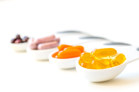 Healthy Supplement capsules in a spoonsの写真素材