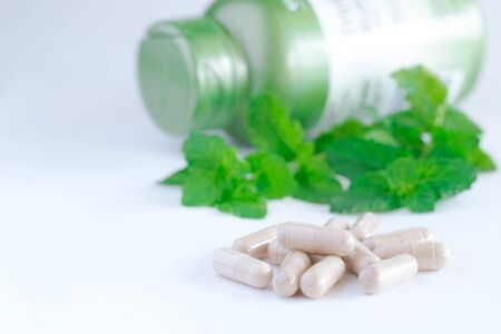 Vitamins supplements or herbal in bottle on white table.の写真素材