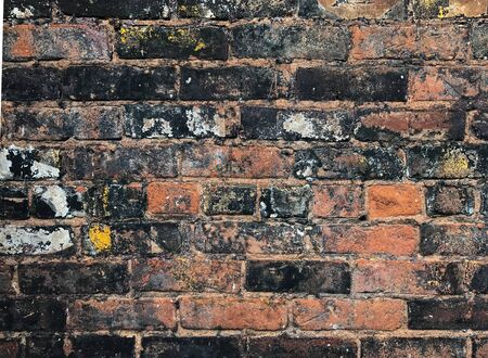 Weathered stained old brick wall background