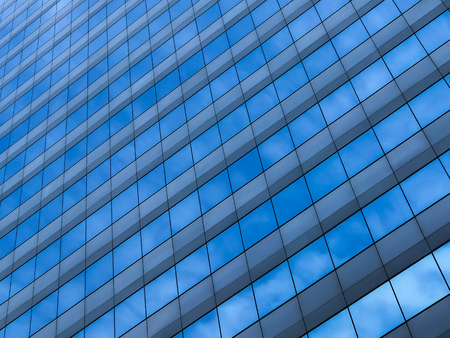 Urban abstract, class windows of office buildings of skyscrapers. And have a reflection of the sky...