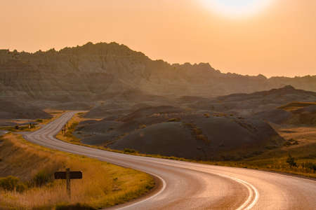 Scenic road at sunset in Badlands National Park.の写真素材