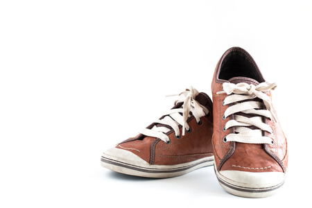 Old dirty sneaker on white background.Male Brown Leather Shoe.の写真素材
