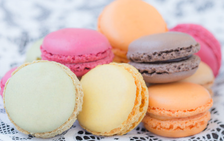 Colorful macaroons on a white lace background.の写真素材