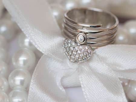 Close up of red rose on white lace and pearls dedorated around.の写真素材