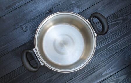 stainless steel pot on wooden backgroundの写真素材