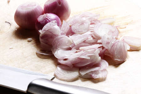 sliced shallots on cutting board