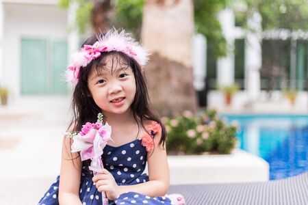 A cute Thai girl with her lovely flower crown.の写真素材