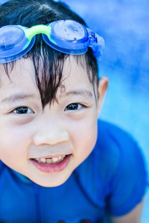 Cute Asian girl at swimming poolの写真素材