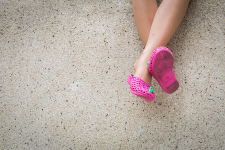 Legs hanging in the air on stone background.の写真素材