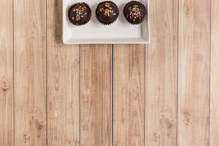 Fresh chocolate ball cakes sprinkled with colorful sugar balls.の写真素材