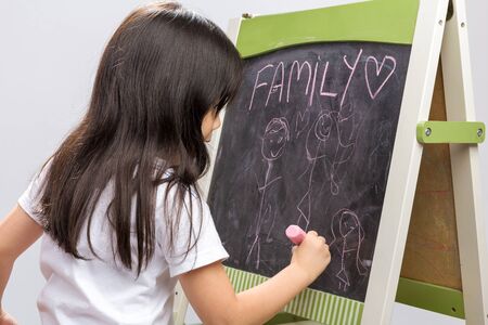 Child Writing on Blackboard Backgroundの写真素材