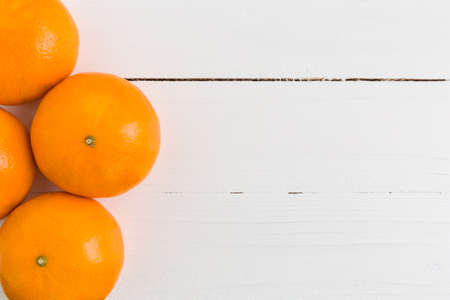 Orange on White Wooden Backgroundの写真素材