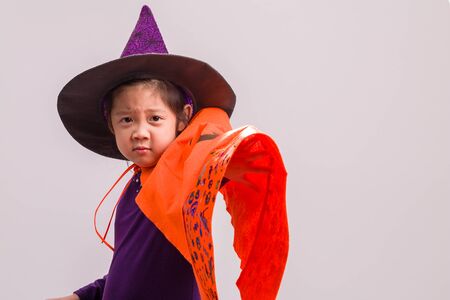 Little Girl in Witch Costume on Whiteの写真素材