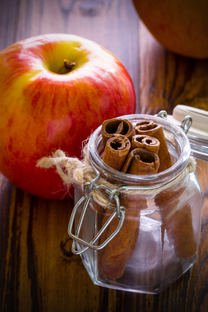 Apple with Cinnamon on Wooden Backgroundの写真素材