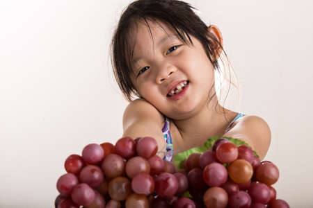 Child Holding Grapes, Isolatedの写真素材