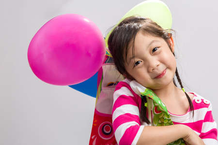 Child Holding Balloons, Isolatedの写真素材