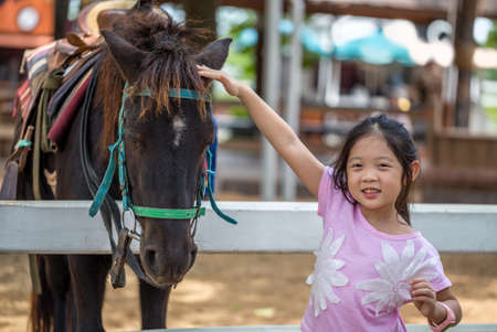 Child with Horse in Farmの写真素材