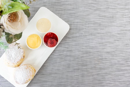 Scone with Jam and Cream on Table Backgroundの写真素材