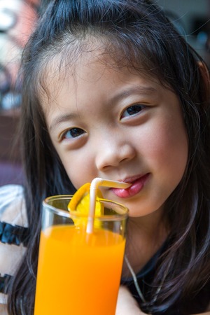 Kid Drinking Orange Juiceの写真素材