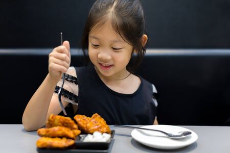 Child Eating Fried Chickenの写真素材