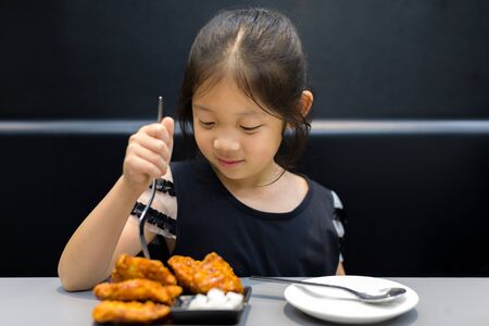 Kid Eating Fried Chickenの写真素材