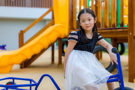 Child Riding on Bike in Playgroundの写真素材