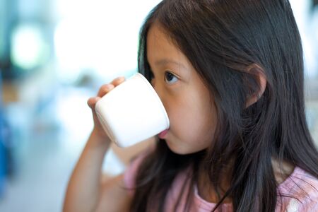 Child Drinking Water from Cupの写真素材