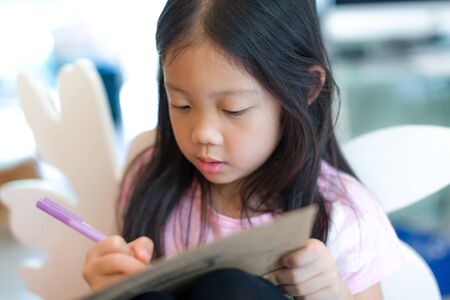 Kid Writing on Notebookの写真素材
