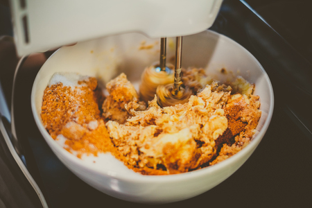Mixing Cookie Ingredients in Bowl by Mixer, Vintage Lookの写真素材