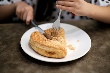 Eating Apple Puff Turnover Pastryの写真素材