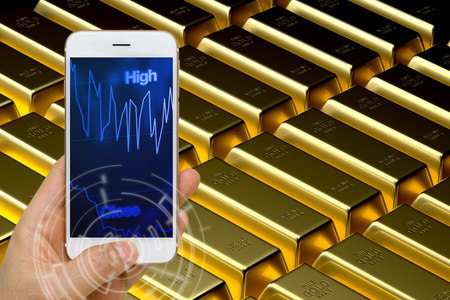 Gold Price Trading Concept Using Smartphone or Smart Device to Monitor Real Time Fluctuationの写真素材