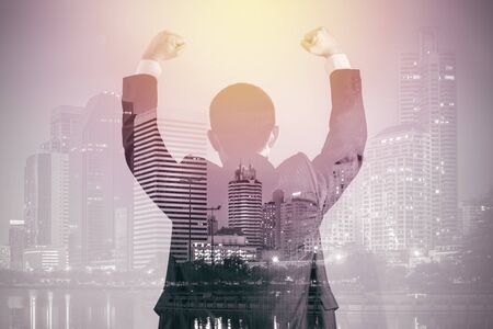 Double Exposure of Businessman in Suit with City Background Illustrating Business Success Conceptの写真素材