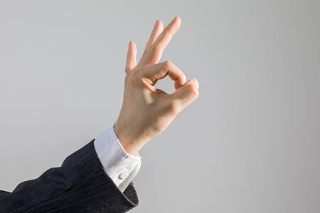 Hand OK Sign of Businessman in Suit as Concept of Agreement, Isolated on White, Studio Shotの写真素材