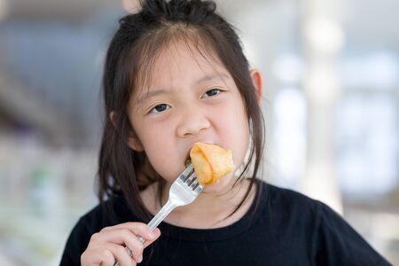 Asian Kid Enjoy Eating Food, Fried Spring Rollの写真素材