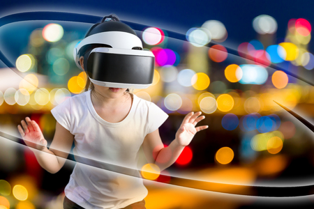 VR or Virtual Reality Concept Illustrated by Asian Child Wearing VR Headset Exploring Virtual Worldの写真素材