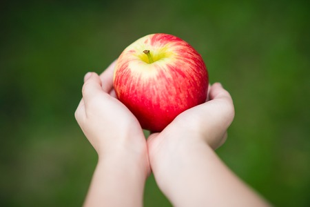 Concept of Healthy Lifestyle Illustrated by Hands Holding Appleの写真素材
