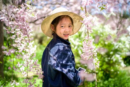 Asian girl on her travelling trip for vacation holding camera to take photo.の写真素材