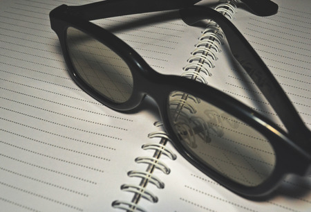 reading glasses and a white noteの写真素材