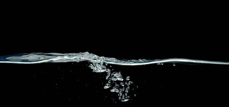 Dark water waves isolated on black background.の写真素材