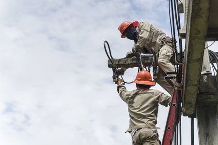 Electricians are working on low-voltage equipment maintenance.の写真素材