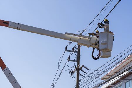 Maintenance of electricians working on high voltage on bucketの写真素材