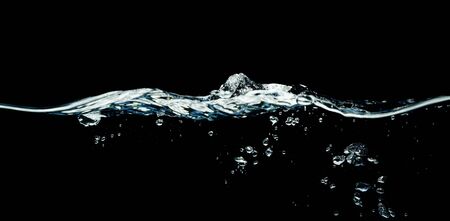 Dark water waves isolated on black background.の写真素材